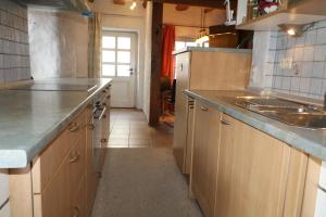 a kitchen with wooden cabinets and a counter top at Milchhäusle in Söllingen