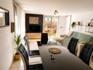 a living room with a couch and a table at ''Le Nid du Forez'' appartement 2 chambres , parking gratuit ,terrasse privative in Prétieux