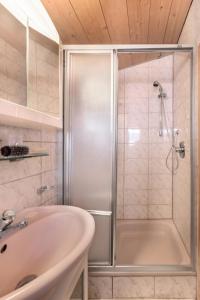 a bathroom with a shower and a sink at Hütte Wilfried in Hainzenberg +8 photos