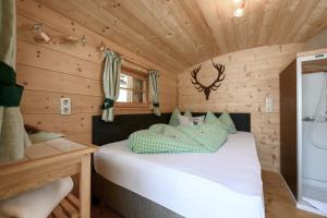 a bedroom with a bed in a wooden cabin at Hütte Wilfried in Hainzenberg