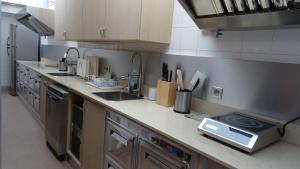 a kitchen with a sink and a counter top at Residence Club Inn in Nice
