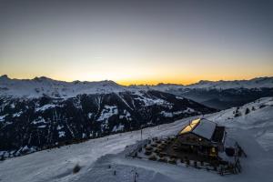 a building on top of a snow covered mountain at Cabane Bella-Tola in Saint-Luc +16 photos