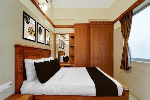 a bedroom with a bed and a window at Hotel O Stay First in Coimbatore