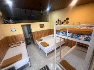 a room with three bunk beds in it at Green Fog Guesthouse in Lonavala