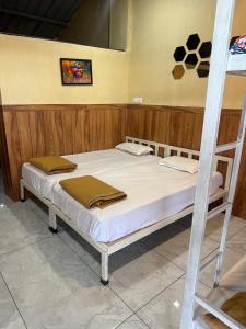 a bed in a room with a bunk bed at Green Fog Guesthouse in Lonavala
