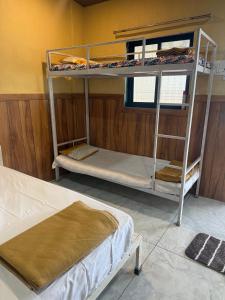 a room with two bunk beds and a bed at Green Fog Guesthouse in Lonavala +24 photos