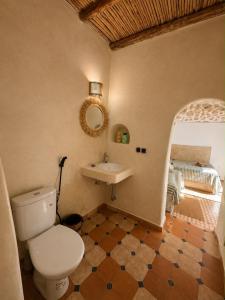 a bathroom with a toilet and a sink at SIDI KaouKI PERLA in Sidi Kaouki +75 photos