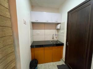 a small kitchen with a sink and a counter at Blue Hills Resort Vythiri in Vythiri