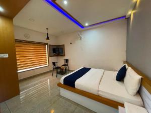 a bedroom with a bed with a blue light on the ceiling at Blue Hills Resort Vythiri in Vythiri +10 photos