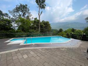 a swimming pool with a view of the mountains at Blue Hills Resort Vythiri in Vythiri
