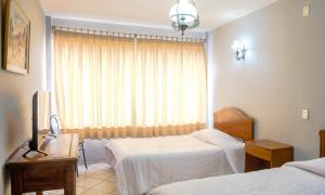a hotel room with two beds and a window at Hotel Marsal in Antofagasta +34 photos