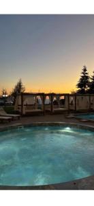a swimming pool with a sunset in the background at Hill residence A 119 Boby in Cajetina