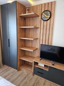 a room with a tv and a wooden wall at Hill residence A 119 Boby in Cajetina