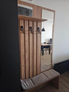 a mirror sitting on a bench in a room at Hill residence A 119 Boby in Cajetina +8 photos