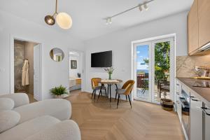 a kitchen and living room with a table and chairs at B&B Villa Dubrovnik Garden in Dubrovnik