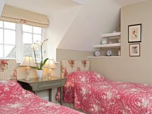 A bed or beds in a room at Wychwood Cottage