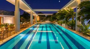 a swimming pool in a villa at night at FARS Hotel & Resorts - BAR-Buffet-Pool-SPA in Dhaka