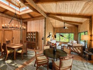 a living room with a table and a dining room at Tiki Treehouse in Keaau