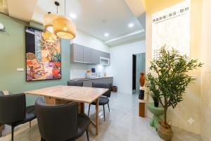a kitchen and dining room with a wooden table and chairs at 原森民宿B&b包棟最佳選擇 in Wujie