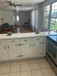 a kitchen with white cabinets and a counter top at Bankston House B&C in Marietta +7 photos