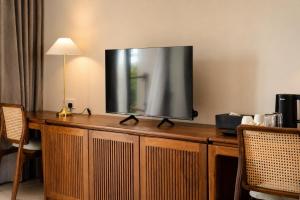 a flat screen tv sitting on top of a wooden cabinet at Rekawa Reach Tangalle in Tangalle