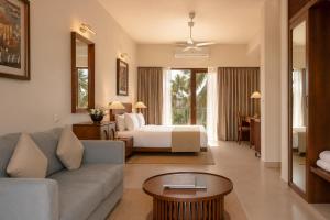 a living room with a couch and a bed in a room at Rekawa Reach Tangalle in Tangalle +15 photos