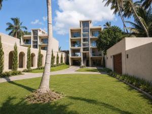 an exterior view of a building with palm trees at Rekawa Reach Tangalle in Tangalle