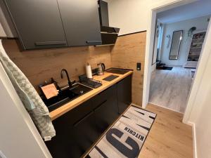 a kitchen with a sink and a counter top at Ferienwohnung Stoll - modern, mit Ausblick & Grill in Idar-Oberstein