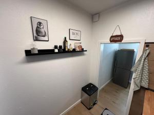 a room with a refrigerator and a shelf on the wall at Ferienwohnung Stoll - modern, mit Ausblick & Grill in Idar-Oberstein +25 photos