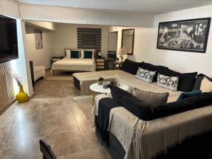 a living room with a couch and a bed at Alfeios cozy stays - Rustic 