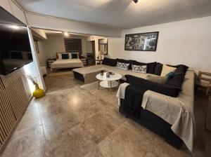 a living room with a couch and a table at Alfeios cozy stays - Rustic  +2 photos