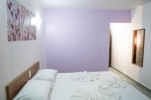 a bedroom with two beds and a painting on the wall at Manacá Hotel in Foz do Iguaçu