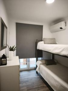 a room with two bunk beds and a window at Los Titos in Arriate