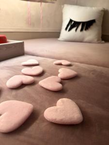 a group of pink hearts on a bed at Salève Glamping in Archamps +13 photos