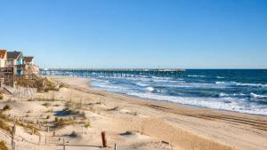 a view of a beach with a pier at Rio Rodanthe Lazy River Kiddie Pool Oceanfront Elevator in Rodanthe