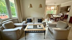 a living room with couches and a coffee table at Baltic Garden Villa in Gdynia