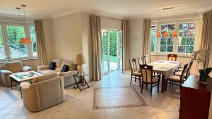 a large living room with a table and chairs at Baltic Garden Villa in Gdynia