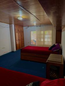 a small room with two beds and a window at Los Horneros in Santa María