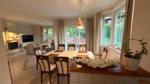 a kitchen and living room with a table and chairs at Baltic Garden Villa in Gdynia