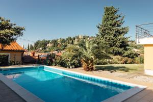 a swimming pool in the yard of a house at Piran Panorama Pool Villa in Piran