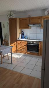 a kitchen with wooden cabinets and a stove top oven at Waldesruh in Pirmasens