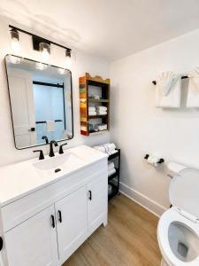 a white bathroom with a sink and a toilet at Boardwalk Noir - Oceanfront Studio Yachtsman 404 in Myrtle Beach +52 photos