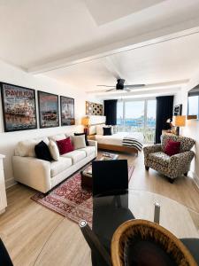 a living room with a couch and a table at Boardwalk Noir - Oceanfront Studio Yachtsman 404 in Myrtle Beach