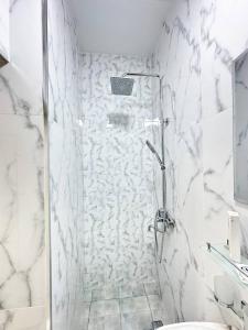 a white bathroom with a shower and a toilet at 10 USD New Hotel in Tashkent +163 photos