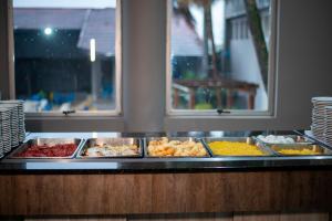 a buffet line with many different types of food at Manacá Hotel in Foz do Iguaçu