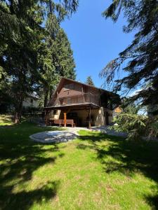 a house with a large yard in front of it at Chata - TYROLEHAUSE in Martin