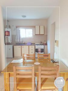 a kitchen with a table and chairs and a dining room at SAN TAURO VIEDMA in Viedma