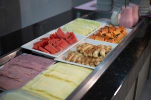 a buffet with many different types of food on display at Manacá Hotel in Foz do Iguaçu