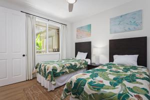 a bedroom with two beds and a window at Fairway Villas Waikoloa by OUTRIGGER in Waikoloa +24 photos