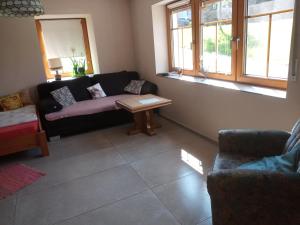 a living room with a couch and a table at Ferienwohnung Otto in Kleinich